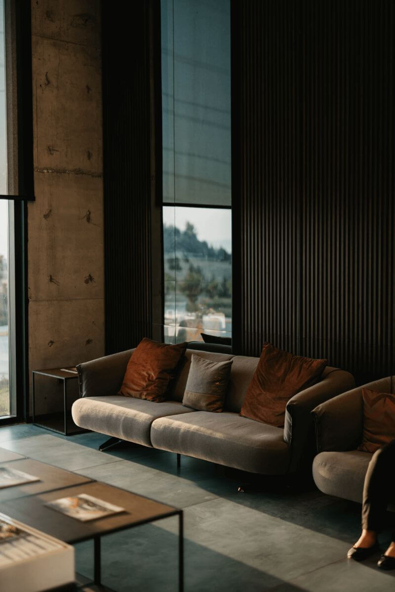 Sofa and pillows in industrial-themed room.