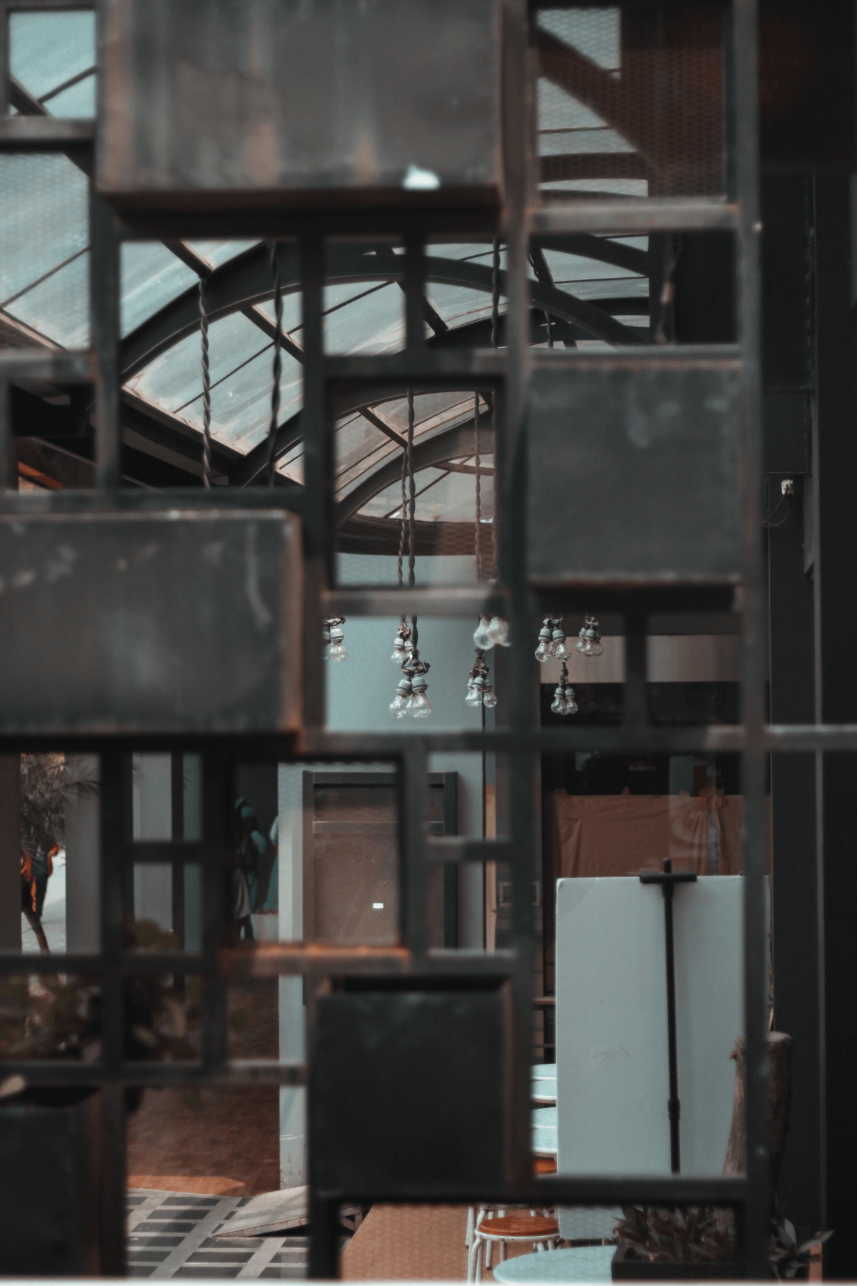 View into industrial living room with artistic lightbulbs.